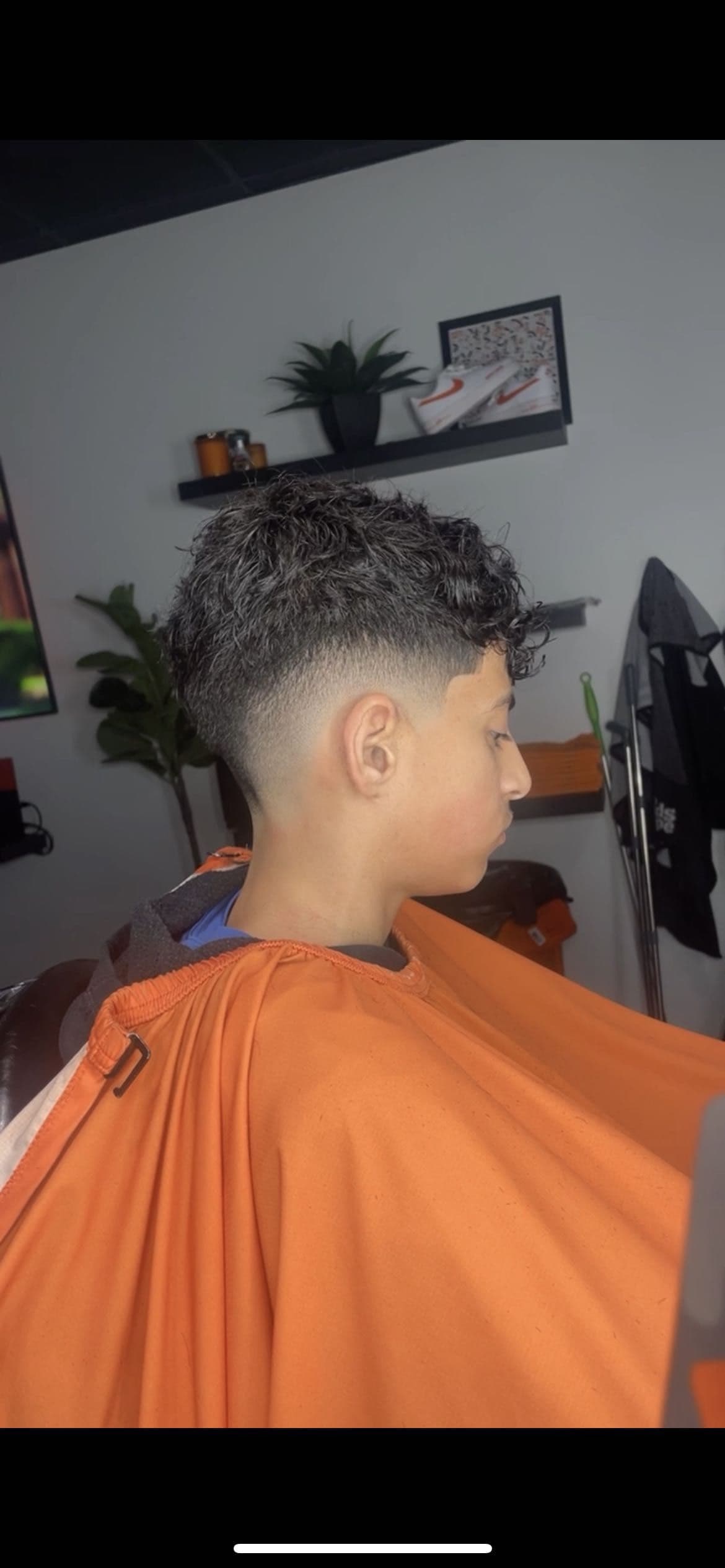 Enhanced fade with curls styled on top by Barber MoeB